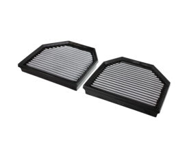 Two rectangular automotive air filters with pleated white media in black plastic frames, shown at an angle on a white background.