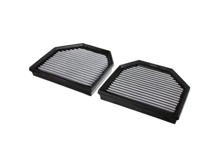 Two rectangular automotive air filters with pleated white media in black plastic frames, shown at an angle on a white background.