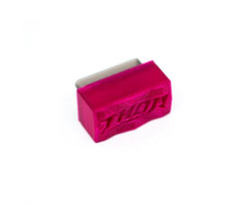 Small pink 3D-printed rectangular block with 'STL' embossed on the side and a metal insert visible inside.