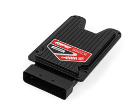 Black automotive suspension controller module with a red label and a multi-pin connector at one end, used to adjust suspension settings.