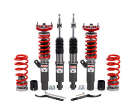 Adjustable coilover suspension kit with red springs and black shock absorbers, plus mounting hardware and wrenches.