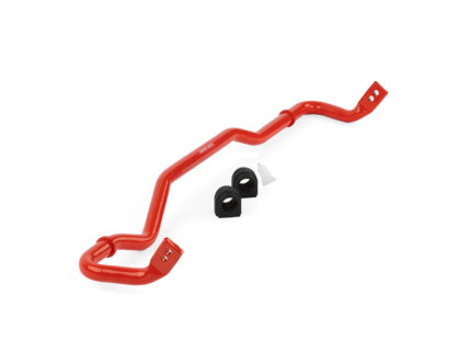 Red automotive sway bar (anti-roll bar) with two black mounting bushings and a white spacer/clip nearby, used in vehicle suspension.